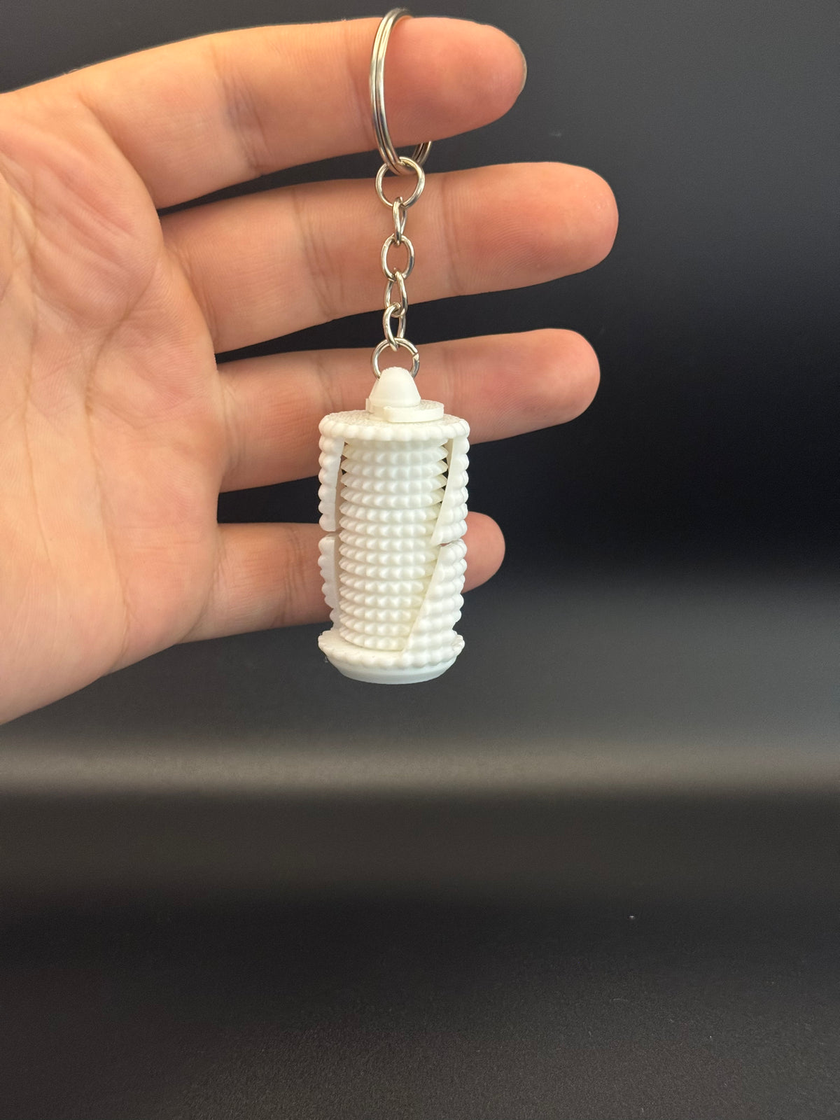 Grenade fidget spinner keyring held in hand